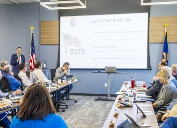 Secretary of State Michael Howe giving a presentation about North Dakota elections to a group of adults.