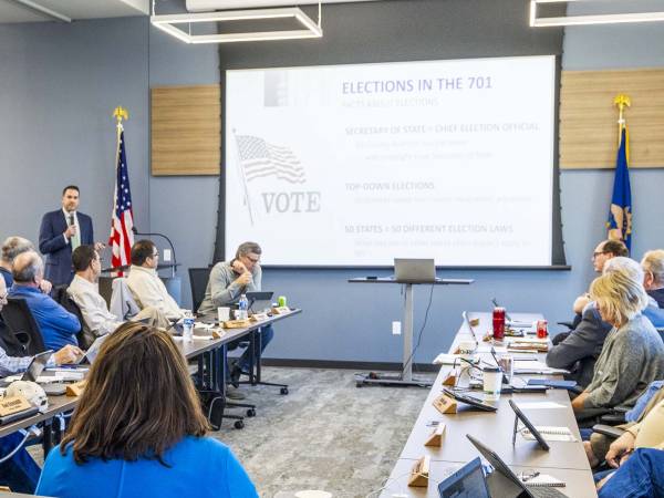 Secretary of State Michael Howe giving a presentation about North Dakota elections to a group of adults.